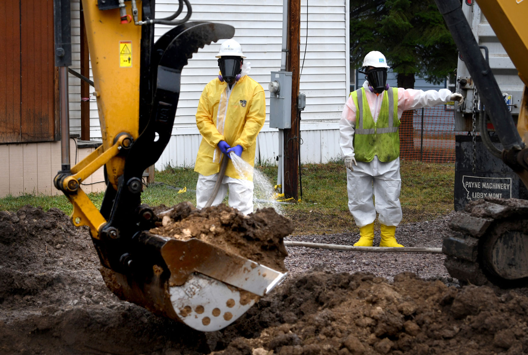 Cleanup workers keep the soil wet